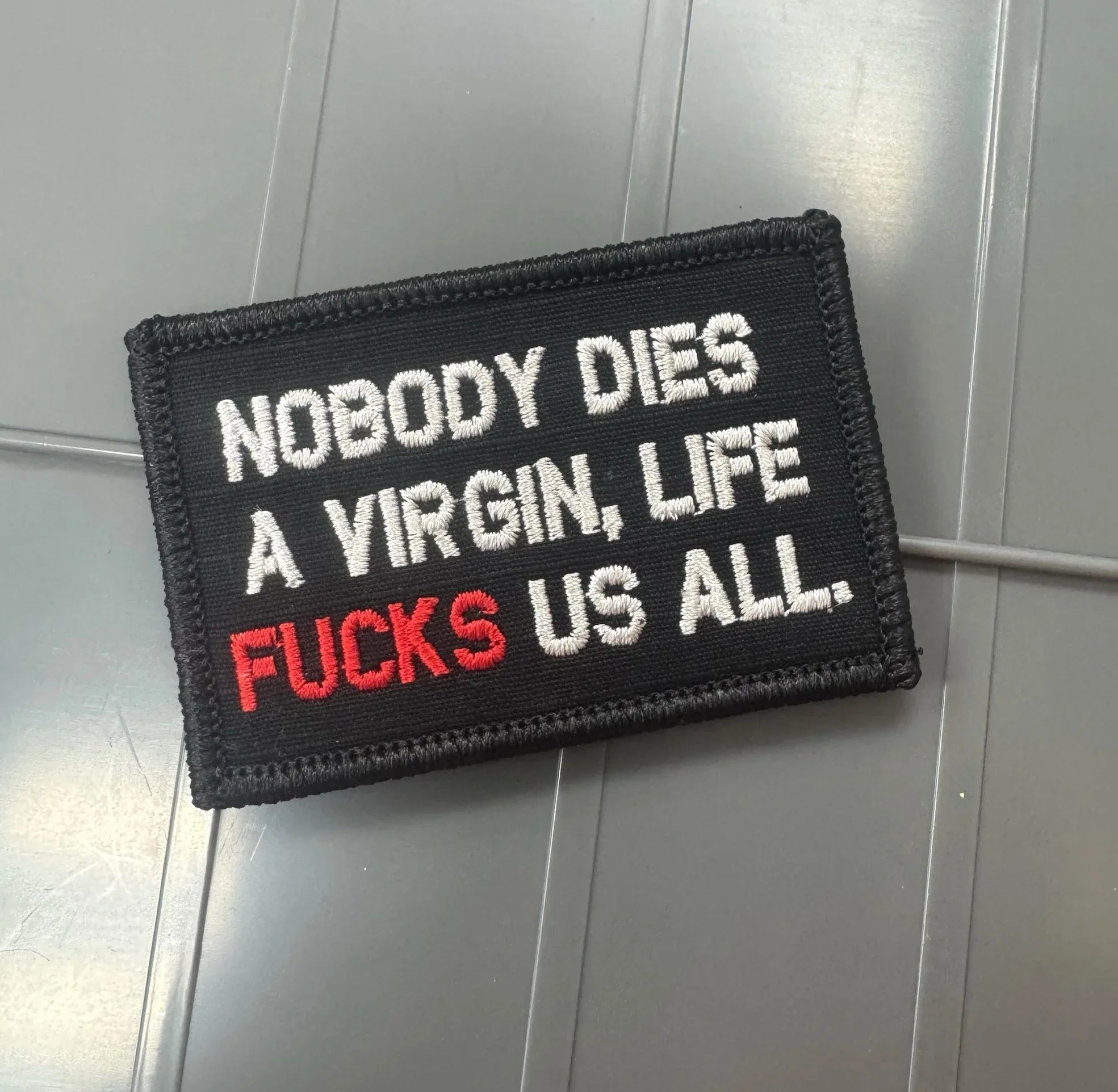 As Seen on Socials - Nobody Dies A Virgin, Life FUCKS Us All - Black w/Silver