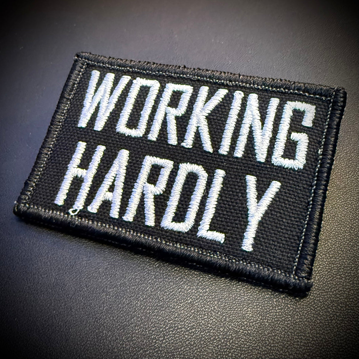 Working Hardly Funny Morale Patch, 2x3" | Made in USA | VELCRO® Brand Hook Backing