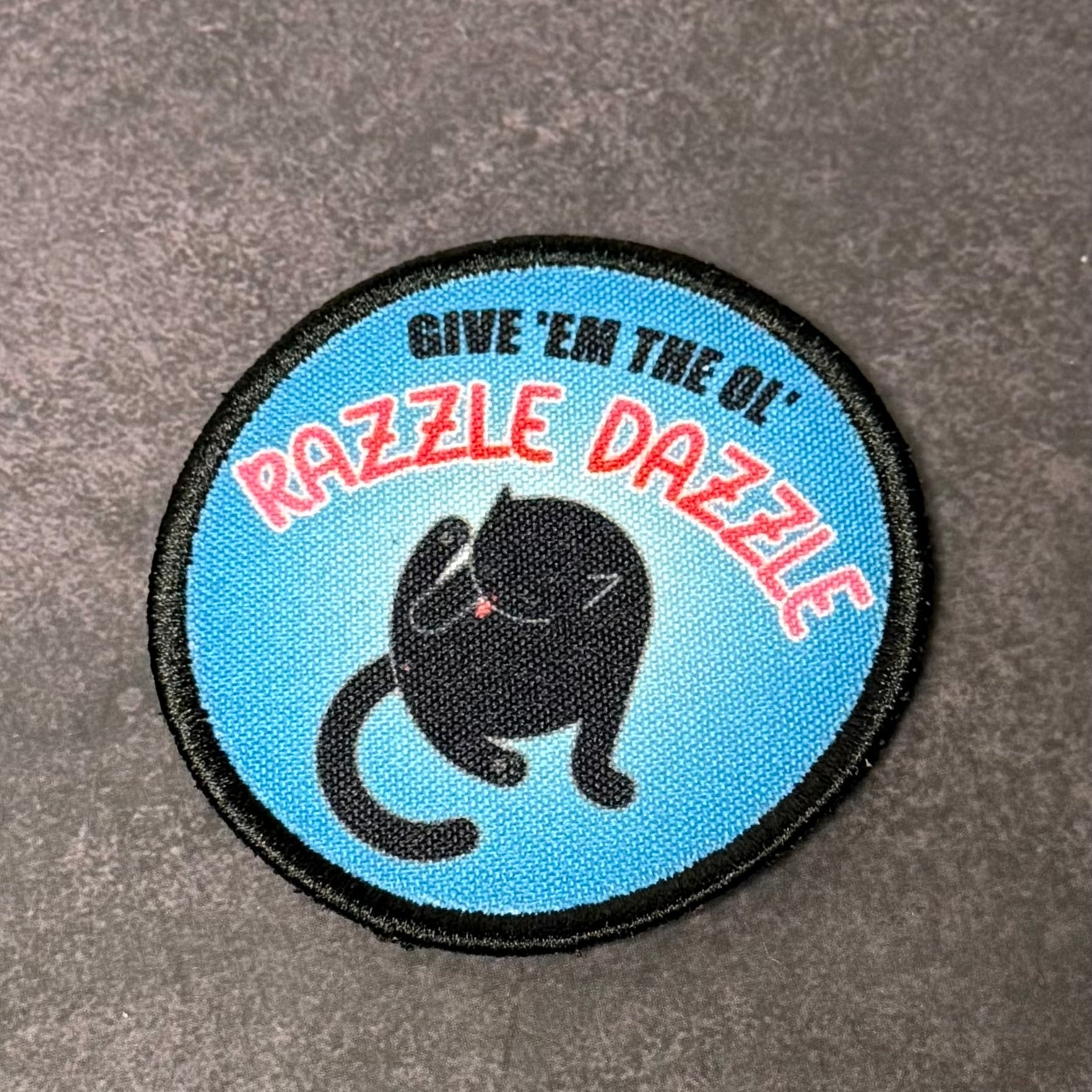 Give 'Em The Razzle Dazzle Funny Morale Patch | Made in USA | VELCRO® Brand Hook Backing