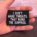 I Don't Make Threats, That Ruins The Surprise Funny Morale Patch, 2x3" | Made in USA | VELCRO® Brand Hook Backing