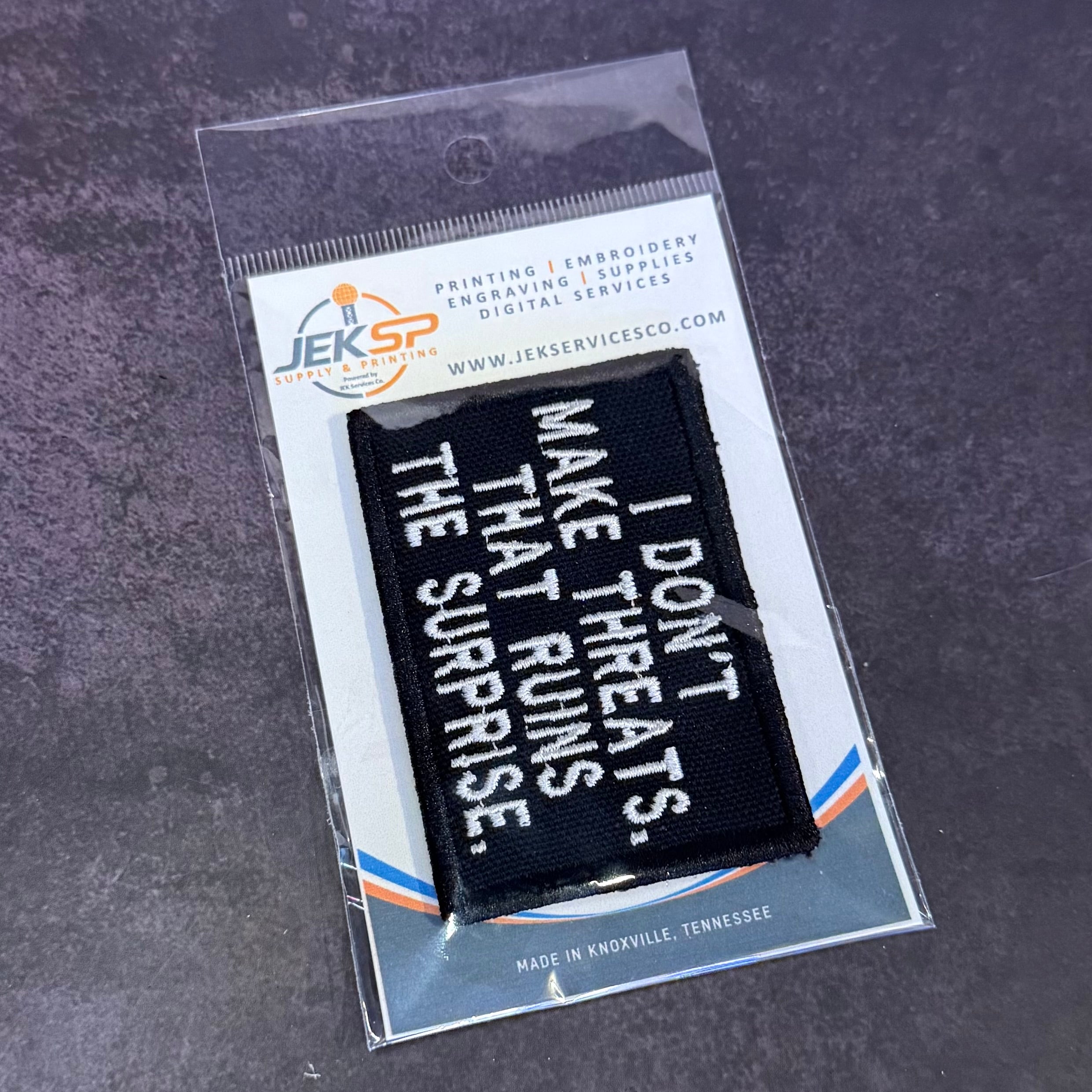I Don't Make Threats, That Ruins The Surprise Funny Morale Patch, 2x3" | Made in USA | VELCRO® Brand Hook Backing