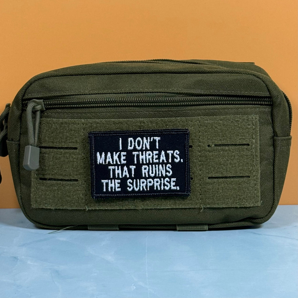 I Don't Make Threats, That Ruins The Surprise Funny Morale Patch, 2x3" | Made in USA | VELCRO® Brand Hook Backing